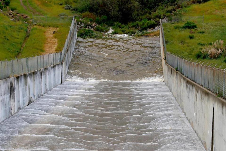 Lake Lopez finally naturally spills over the chute in the early morning, Thursday, Mar. 23, 2023.