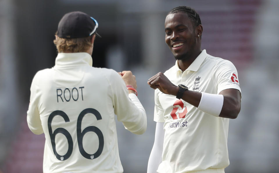 England's Jofra Archer, right, celebrates with captain Joe Root the dismissal of Pakistan's Mohammad Abbas during the second day of the first cricket Test match between England and Pakistan at Old Trafford in Manchester, England, Thursday, Aug. 6, 2020. (Lee Smith/Pool via AP)