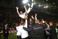 Football Soccer - Germany v England - International Friendly - Signal-Iduna-Park, Dortmund, Germany - 22/3/17 Germany's Lukas Podolski is thrown in the air by teammates after his final appearance for his country Reuters / Wolfgang Rattay Livepic