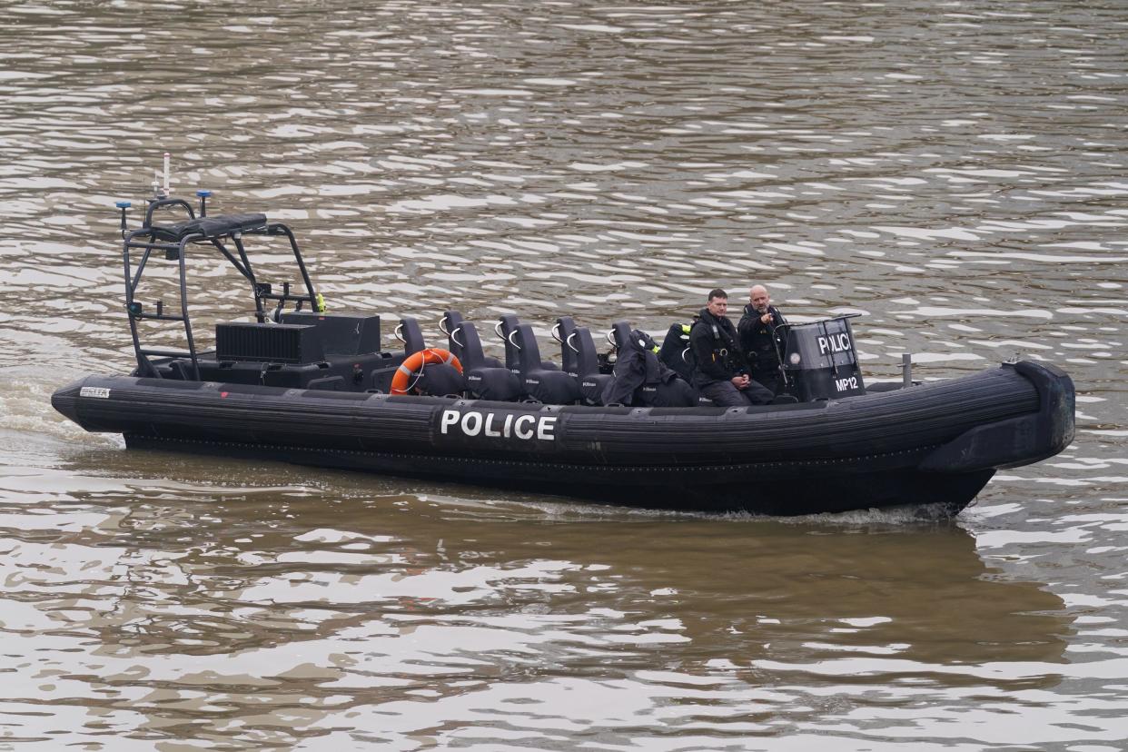 Members of the Metropolitan Police Marine Policing Unit pass near to Chelsea Bridge where they are due to search in relation to alkali attack suspect Abdul Ezedi, who is believed to have 