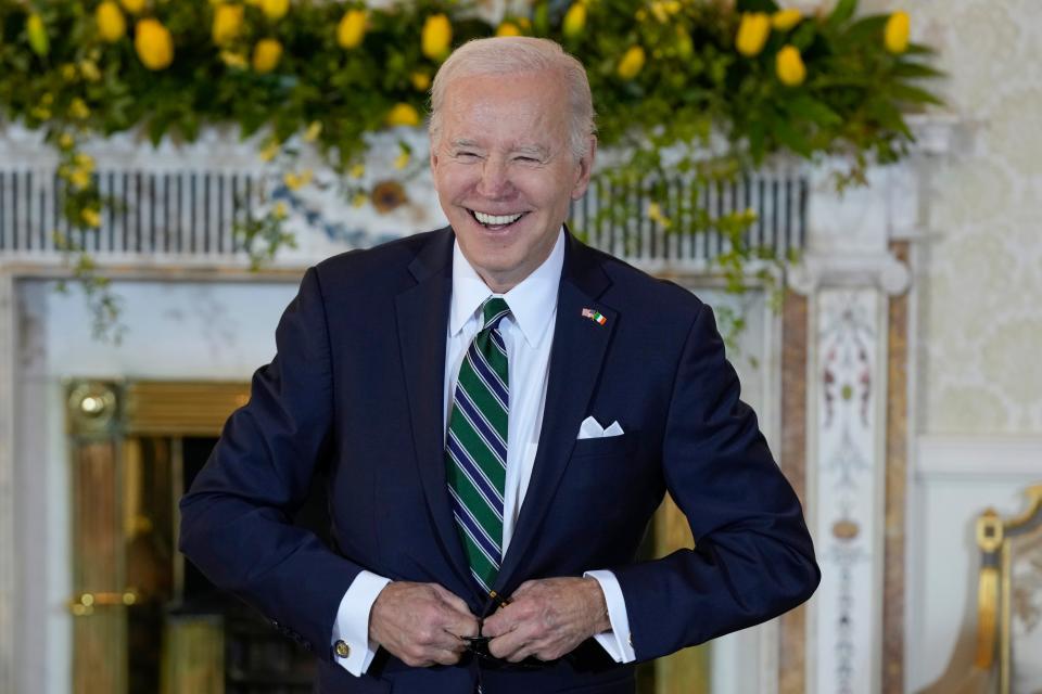 President Joe Biden smiles after signing the guest book as he meets with Irish President Michael Higgins on April 13, 2023 in Dublin, Ireland.