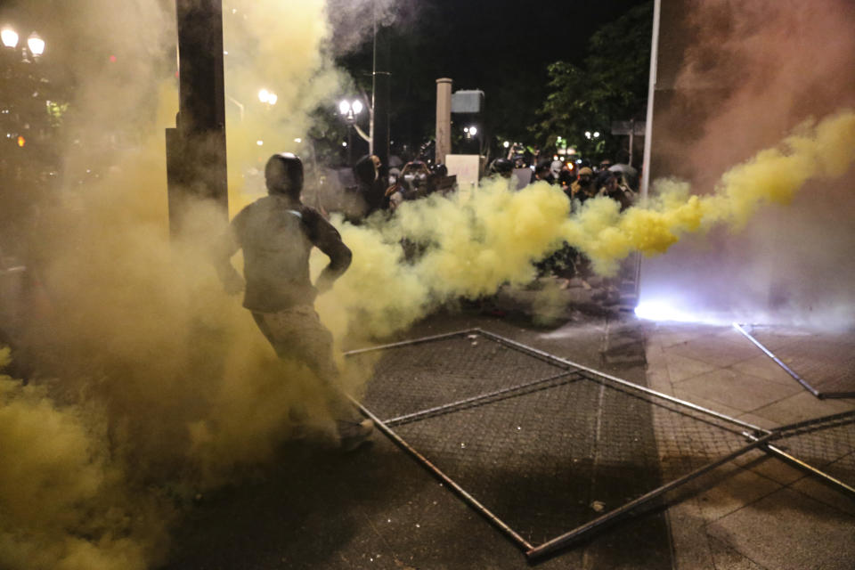 Police respond to protesters during a demonstration, Friday, July 17, 2020 in Portland, Ore. Militarized federal agents deployed by the president to Portland, Oregon, fired tear gas against protesters again overnight as the city’s mayor demanded that the agents be removed and as the state’s attorney general vowed to seek a restraining order against them. (Dave Killen/The Oregonian via AP)