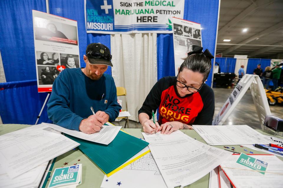 Ashley Markum and Josh Loftis notarize signatures for New Approach Missouri to get the medical marijuana amendment on the November ballot during the Ozark Spring Roundup at the Ozark Empire Fairgrounds on Saturday, March 24, 2018.