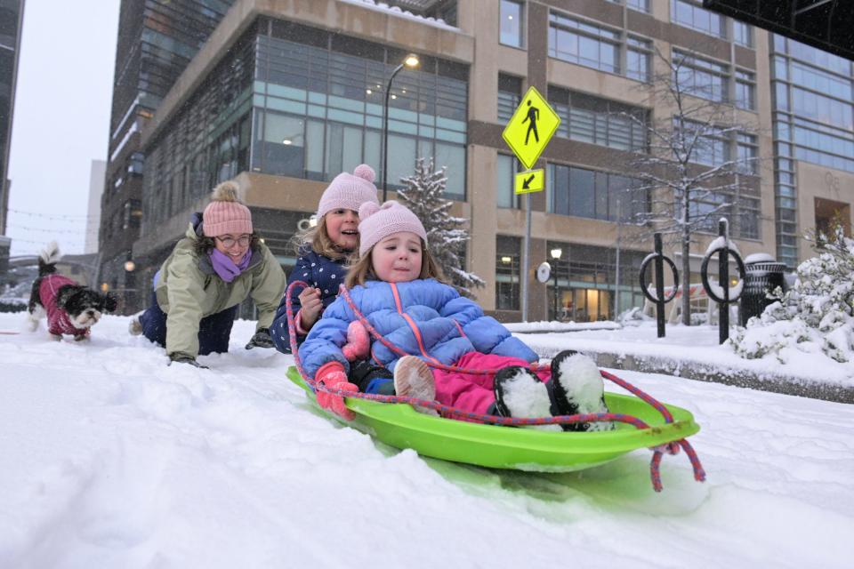Macie Williams, 6, and her sister Alice, 3, sled down Laurens street in downtown Greenville on snow covered much of Greenville on Sunday, Jan. 16, 2022.