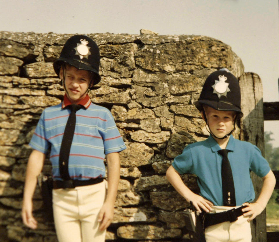 Prince William and Prince Harry pose in borrowed police outfits.