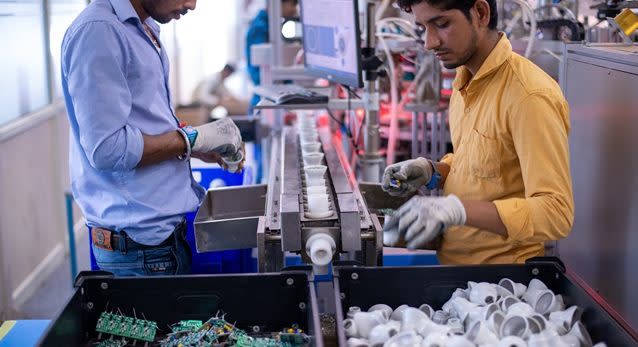 Gurugram, Haryana, India: 28 May 2019- Skilled Workers at a LED lighting factory, working on conveyor belt.