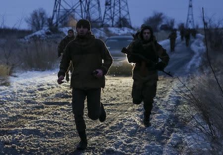 Pro-Russian separatists from the Chechen "Death" battalion run during a training exercise in the territory controlled by the self-proclaimed Donetsk People's Republic, eastern Ukraine, December 8, 2014. REUTERS/Maxim Shemetov