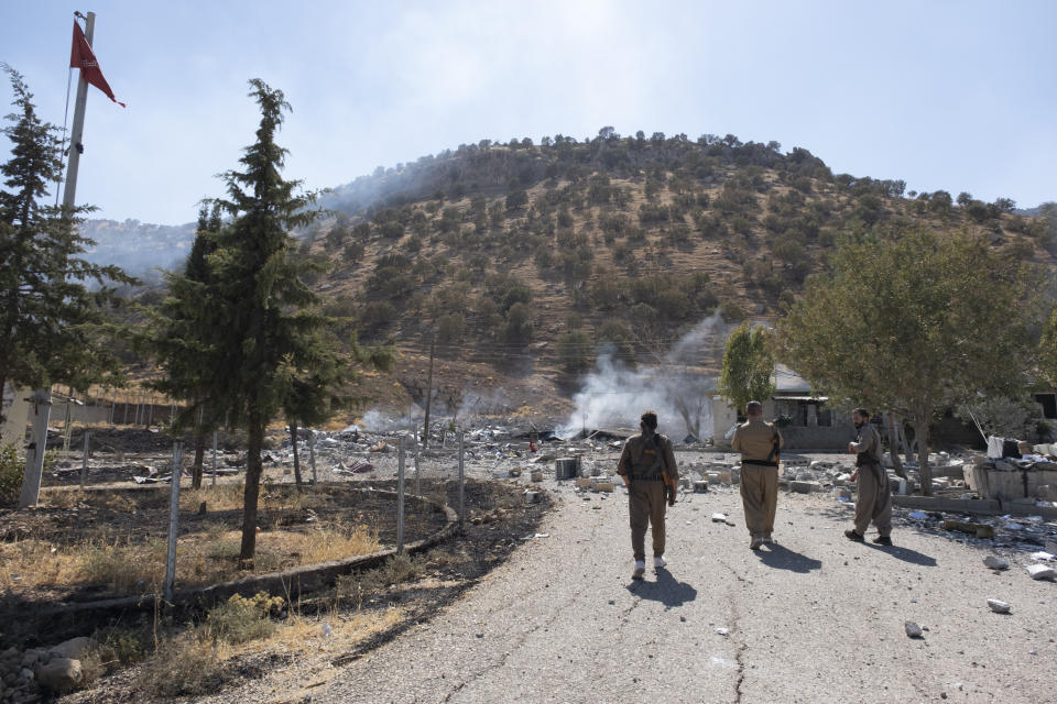 Members of exiled Komala Party inspect aftermath of bombing in the village of Zrgoiz, near Sulaimaniyah, Iraq, where the bases of several Iranian opposition groups are located, Wednesday, Sept. 28, 2022. An Iranian drone bombing campaign targeting the bases of an Iranian-Kurdish opposition group in northern Iraq has killed nd wounded dozens. (AP PhotoAla Hoshyar, Metrography)