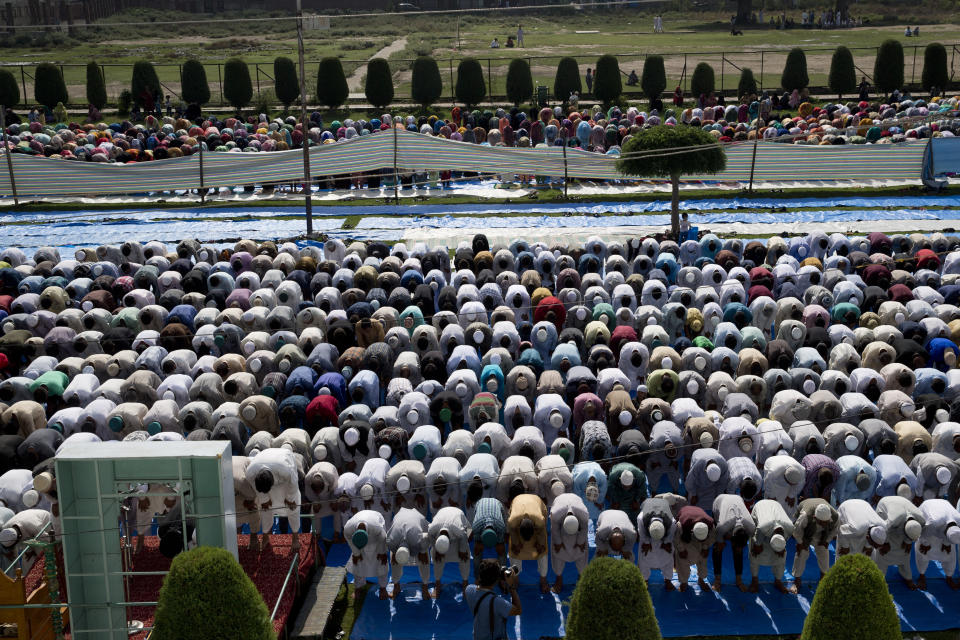 Kashmiri Muslims participate in Eid prayers outside a mosque during a security lockdown in Srinagar, Indian controlled Kashmir, Monday, Aug. 12, 2019. Troops in India-administered Kashmir allowed some Muslims to walk to local mosques alone or in pairs to pray for the Eid al-Adha festival on Monday during an unprecedented security lockdown that still forced most people in the disputed region to stay indoors on the Islamic holy day. (AP Photo/ Dar Yasin)