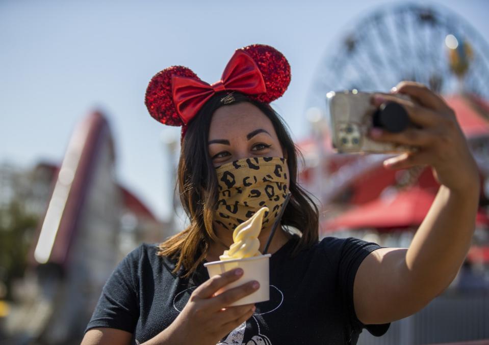 A woman takes a selfie while holding a dessert.