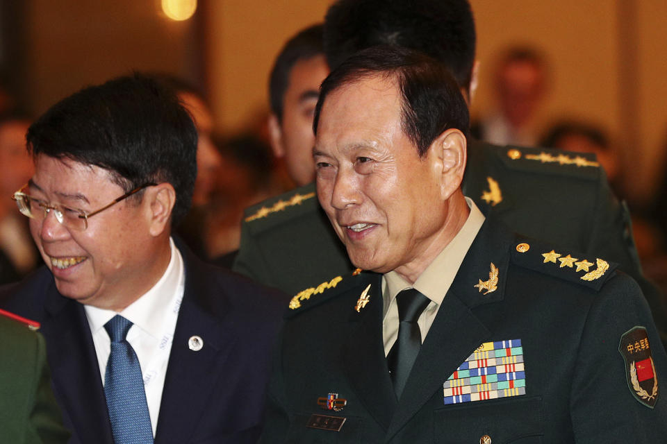 Chinese Minister of National Defense Wei Fenghe, right, arrives for the opening dinner of the 18th International Institute for Strategic Studies (IISS) Shangri-la Dialogue, an annual defense and security forum in Asia, in Singapore, Friday, May 31, 2019. (AP Photo/Yong Teck Lim)