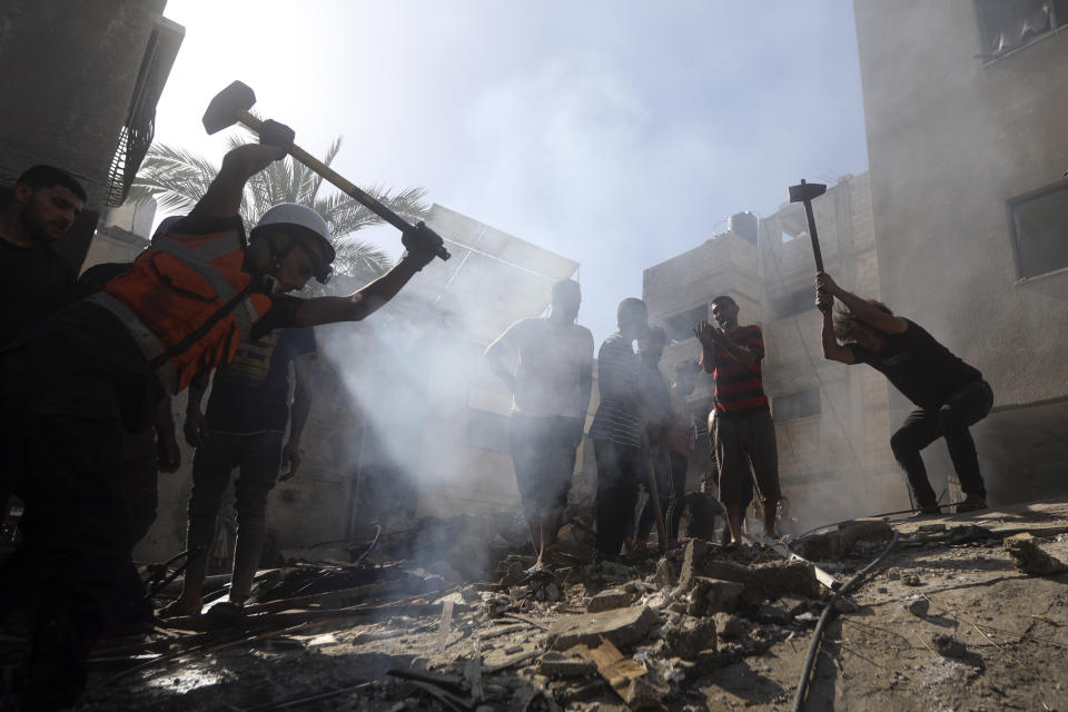 Palestinians look for survivors under the rubble of a destroyed building following an Israeli airstrike in Khan Younis refugee camp, southern Gaza Strip, Monday, Nov. 6, 2023. (AP Photo/Mohammed Dahman)