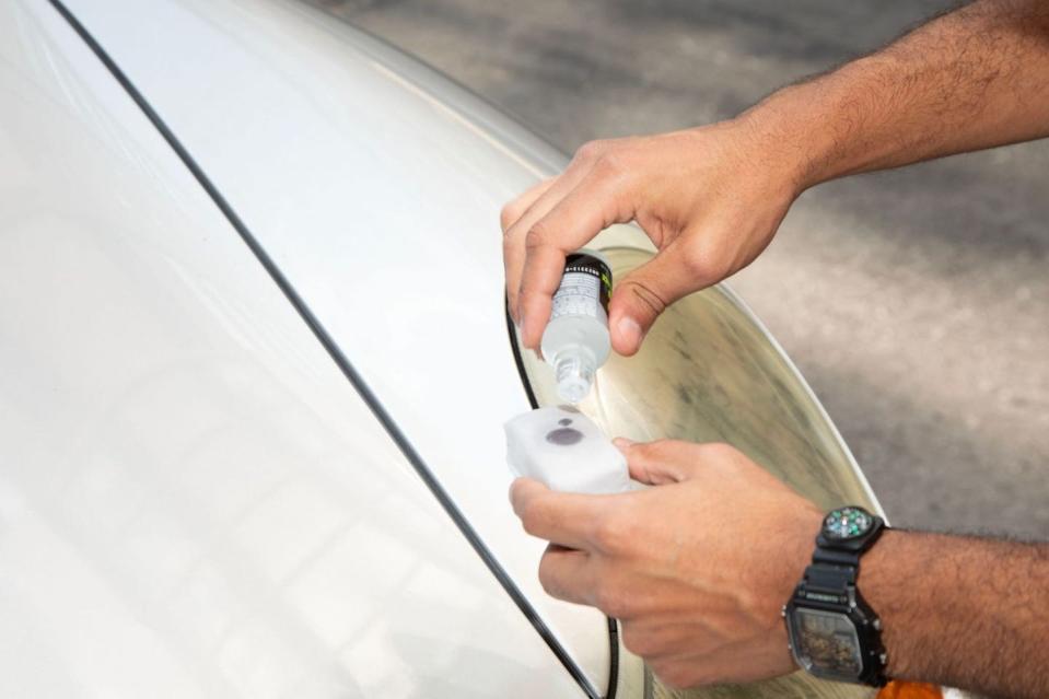 chemical guys ceramic coating being applied to a grey car