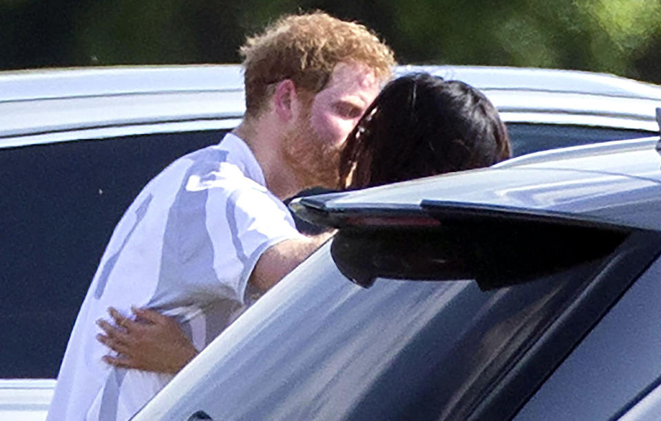 <p>Harry was spotted giving his girlfriend a kiss after taking part in the Audi Polo Challenge in May. With Markle supporting her partner on the sidelines, it was the first time the pair were seen in public together. (Photo: Rex) </p>