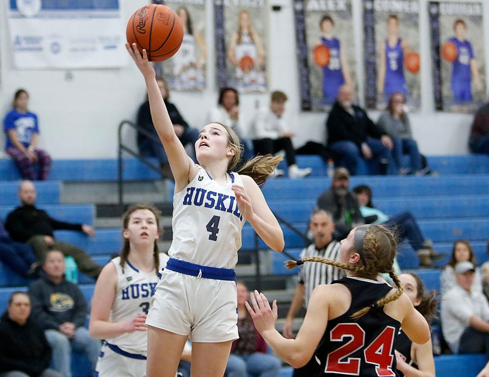 Northwestern High School's Caydence Scale (4) drives in for a lay up against Crestview High School's Emma Aumend (24) during high school girls basketball action Tuesday, Jan. 4, 2021 at Northwestern High School. TOM E. PUSKAR/TIMES-GAZETTE.COM
