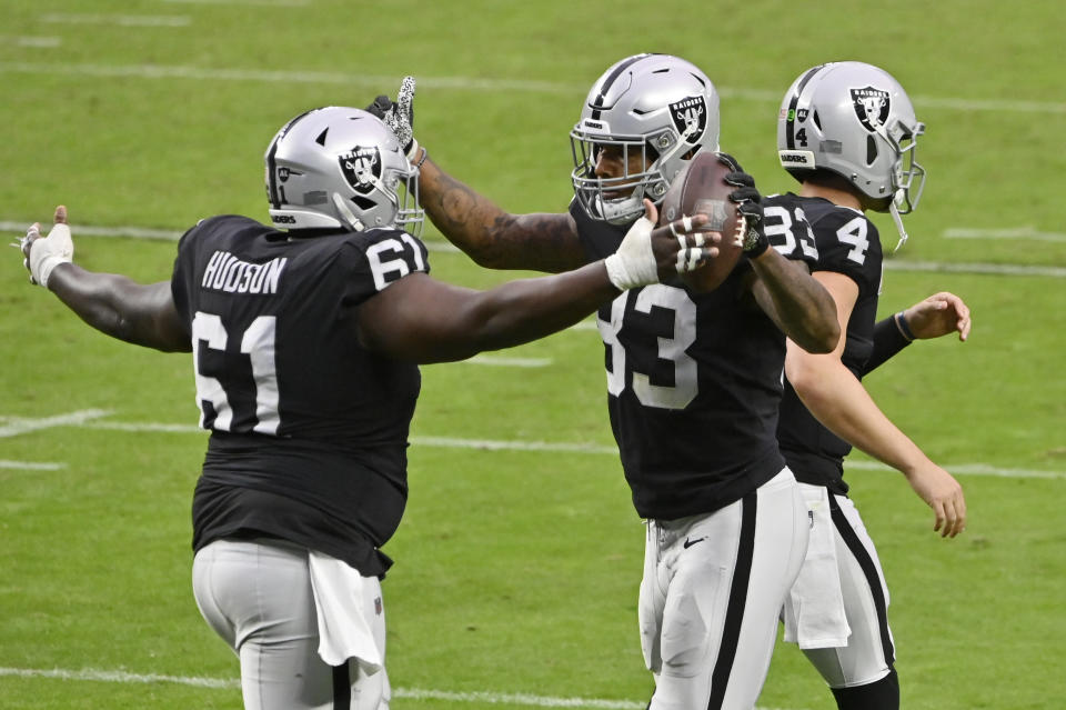 Las Vegas Raiders center Rodney Hudson (61) celebrates with tight end Darren Waller (83) after Waller scored a touchdown against the Tampa Bay Buccaneers during the second half of an NFL football game, Sunday, Oct. 25, 2020, in Las Vegas. (AP Photo/David Becker)