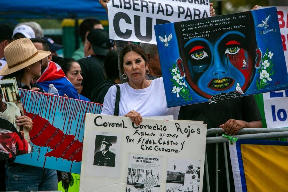 MIAMI, FL- March 19, 2023 - Demonstrators hold signs and shout slogans to protest the the game between the United States and Cuba in front of loanDepot Park prior to the baseball game.