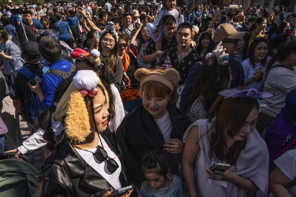 Visitors enter the World of Frozen themed area during its opening ceremony at Disneyland Resort in Hong Kong, Monday, Nov. 20, 2023. (AP Photo/Louise Delmotte)