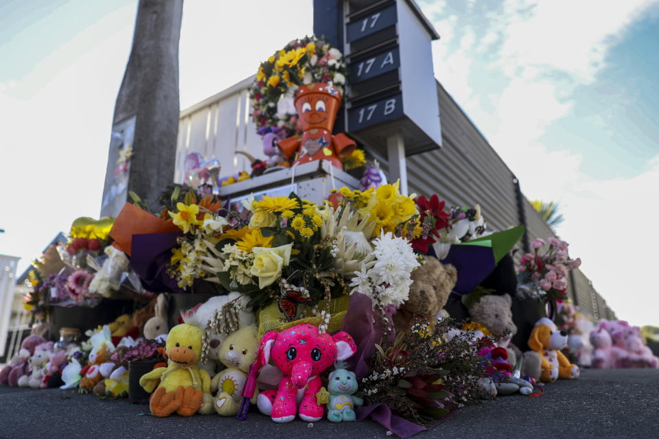 Gifts are placed outside the home in Timaru, New Zealand, Thursday, Sept. 23, 2021 for sisters Maya, Karla and Liane Dickason, originally from South Africa, who were killed in their home on Sept. 16. People in the town of Timaru held an evening vigil outside the home of three young girls who were killed last week in a crime that shocked New Zealand. The girls' mother Lauren Dickason has been charged with murder. (George Heard/New Zealand Herald via AP)