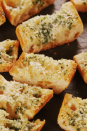 <p>The secret to really good garlic bread is to keep it simple. And to use a lot of garlic—4 cloves for one loaf!</p><p>Get the <a href="https://www.delish.com/uk/cooking/recipes/a30255379/easy-garlic-bread-recipe/" rel="nofollow noopener" target="_blank" data-ylk="slk:Classic Garlic Bread;elm:context_link;itc:0;sec:content-canvas" class="link ">Classic Garlic Bread</a> recipe.</p>