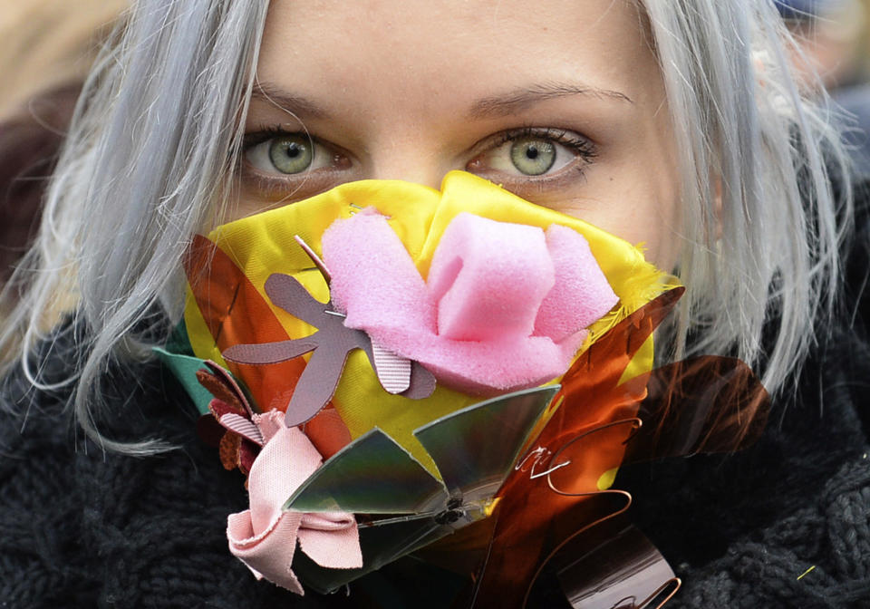 A climate activists with a colorful mask attends the March for Climate in a protest against global warming in Katowice, Poland, Saturday, Dec. 8, 2018, as the COP24 UN Climate Change Conference takes place in the city. (AP Photo/Alik Keplicz)