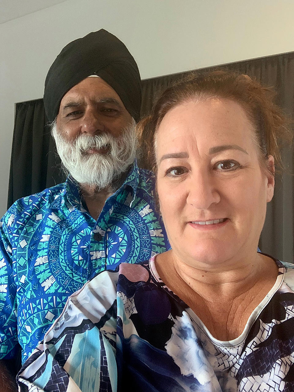 In this photo provided by Sandy Price, Price and her husband, Pal Ahluwalia, pose for a photo in Brisbane, Australia, Friday, Feb. 5, 2021. Ahluwalia, the leader of the University of the South Pacific, and his wife were asleep Wednesday at their Fiji home when a ruckus outside awoke them near midnight. About 15 plain-clothed government agents had surrounded their house in the capital Suva and gave them minutes to pack before they were hastily deported to Australia. (Sandy Price via AP)