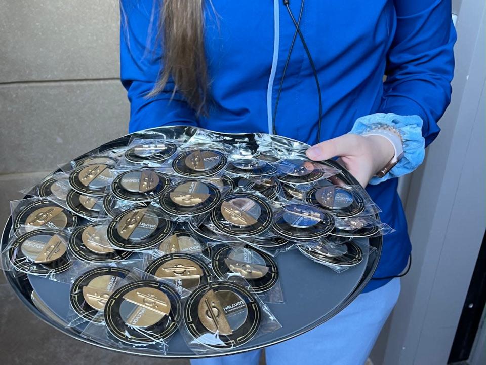 A Disney employee holding a tray of pins for Starcruiser guests