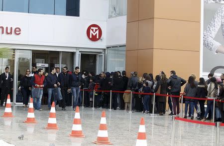 People wait in line to enter the Tunisia Mall in Berges du Lac in Tunis, Tunisia, December 20, 2015. REUTERS/Zoubeir Souissi