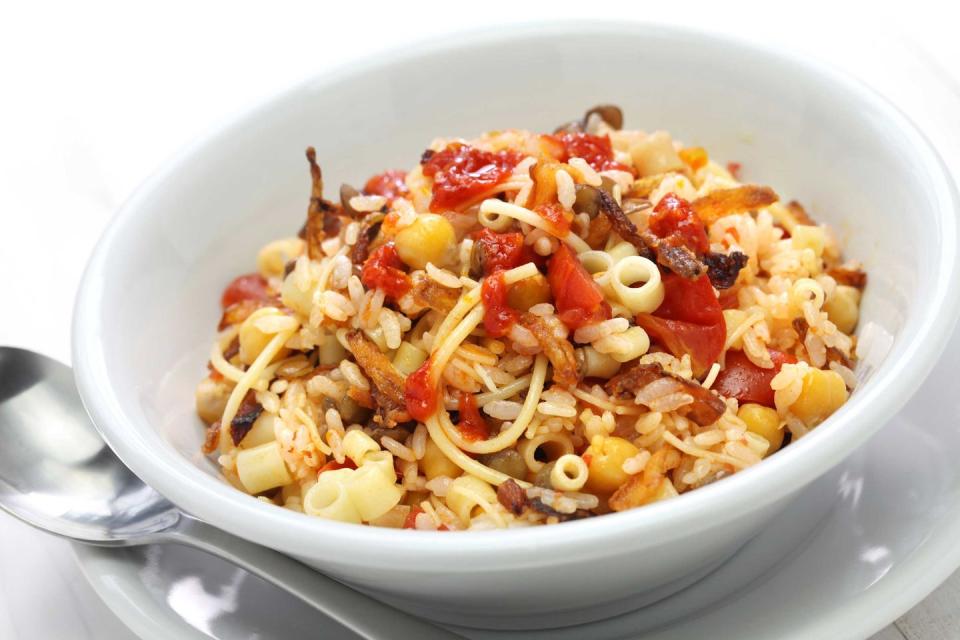 <p>The best way to describe Koshari is a vegetarian Egyptian-style chili. Wildly popular as Egyptian street food as their national dish, it’s a cultural fusion combining Italian, Indian and Middle Eastern roots. It defines <a href="https://www.countryliving.com/food-drinks/g30626253/healthy-comfort-food/" rel="nofollow noopener" target="_blank" data-ylk="slk:comfort food;elm:context_link;itc:0;sec:content-canvas" class="link ">comfort food</a> as it consists of: spiced lentils, rice, chickpeas and small pasta, topped with tomato sauce and crispy thin fried onion rings.</p><p><strong>Get the recipe at <a href="https://www.themediterraneandish.com/egyptian-koshari-recipe/" rel="nofollow noopener" target="_blank" data-ylk="slk:The Mediterranean Dish;elm:context_link;itc:0;sec:content-canvas" class="link ">The Mediterranean Dish</a>.</strong></p>