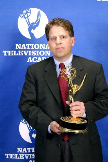 Norby Williamson holds an Emmy award during 26th Annual Sports Emmy Awards in 2005.