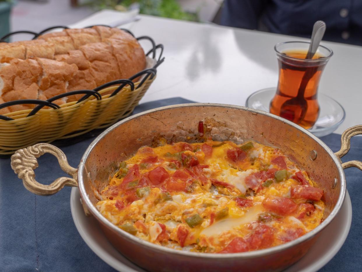 Dish of Menemen with bread and tea