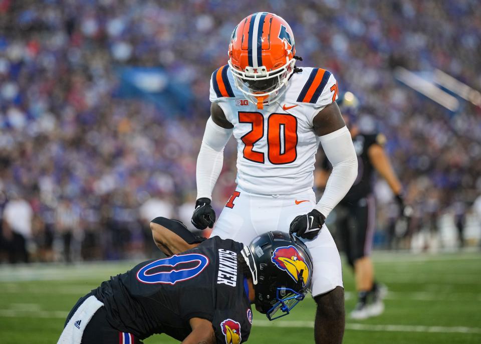 Sep 8, 2023; Lawrence, Kansas, USA; Illinois Fighting Illini defensive back Tyler Strain (20) celebrates after tackling Kansas Jayhawks wide receiver Quentin Skinner (0) during the first half at David Booth Kansas Memorial Stadium. Mandatory Credit: Jay Biggerstaff-USA TODAY Sports