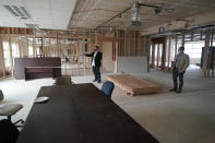 Garth Reeves, left, and Scott Canfield, co-founders of the Why Not You Academy charter school, stand in what will be the school's common area, Tuesday, Oct. 27, 2020, inside the building being renovated to house the school in Des Moines, Wash., south of Seattle. Seattle Seahawks NFL football quarterback Russell Wilson and his Grammy-winning wife, pop singer Ciara, are putting their money and celebrity behind rebranding the charter school, which advocates hope will boost the troubled Washington state charter school sector that has suffered from enrollment problems after years of legal challenges. (AP Photo/Ted S. Warren)