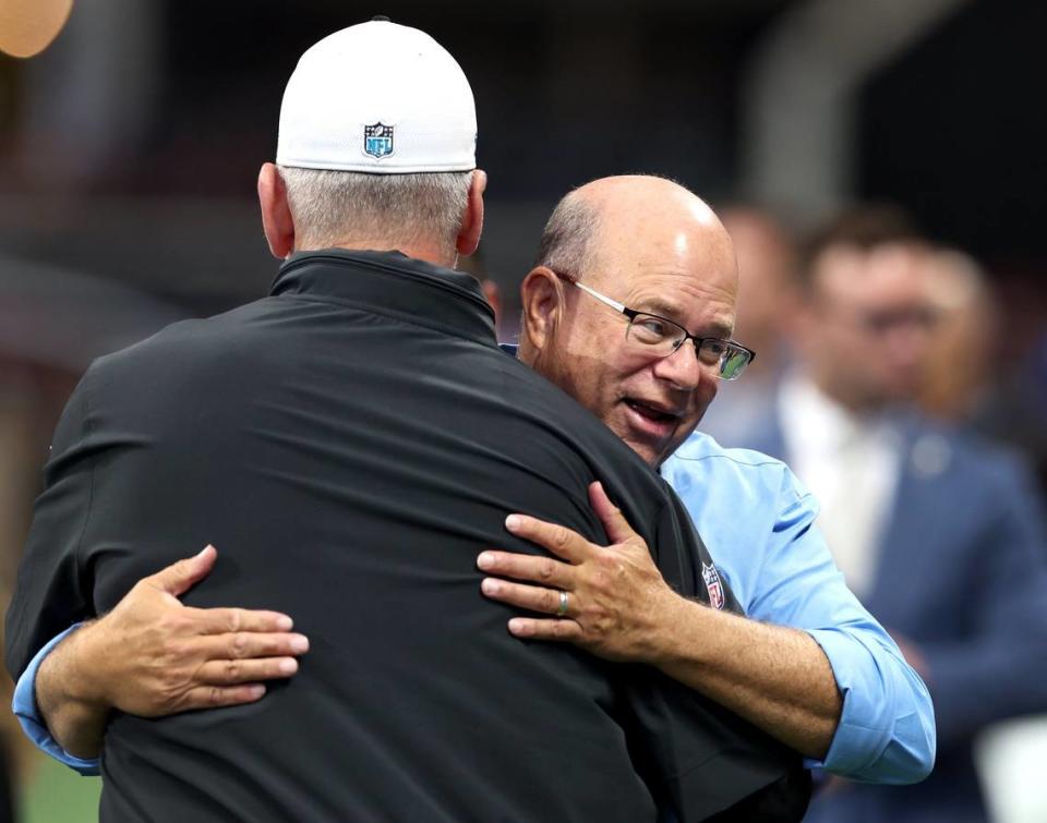 Carolina Panthers head coach Frank Reich, left, gets a big hug from team owner David Tepper, right, prior to the team’s game against the Atlanta Falcons at Mercedes-Benz Stadium in Atlanta, GA on Sunday, September 10, 2023.