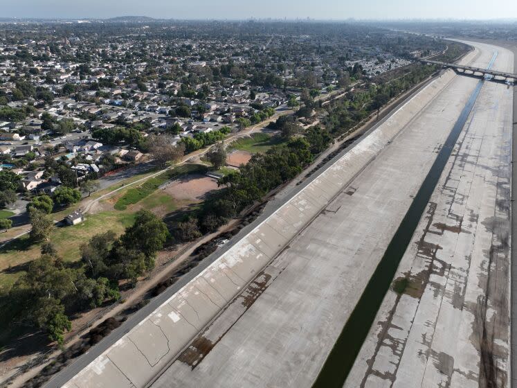 Long Beach, CA - October 05: An aerial view of the Los Angeles River west of DeForest Park in North Long Beach and the neighborhood east of the river and park in Long Beach, Wednesday, Oct. 5, 2022. A new UCI study warns that a major food would hit Los Angeles County's low-lying Black communities disproportionately hard. Working-class neighborhoods adjacent to the Los Angeles River in North Long Beach, for example, would be under six feet of water. (Allen J. Schaben / Los Angeles Times)