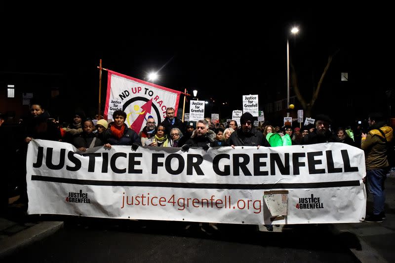 FILE PHOTO: People take part in a silent candlelit march to mark the six-month anniversary of the Grenfell Tower fire in London