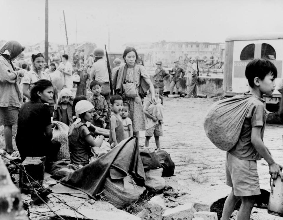 Filipino survivors gather after their liberation by U.S. troops on Feb. 23, 1945.