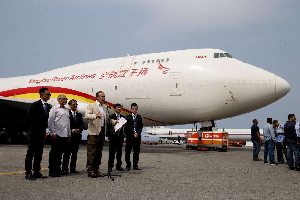 Industry and National Production Minister Tareck El Aissami speaks to reporters next to a Chinese airplane at the Simon Bolivar International Airport in Maiquetia, near Caracas, Venezuela, Friday, March 29, 2019. Aid was unloaded from the plane in what Venezuelan officials said would be the first delivery of many from China, an ally of the government of President Nicolas Maduro. (AP Photo/Natacha Pisarenko)