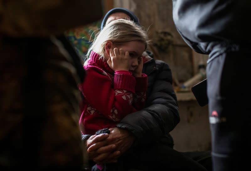 Arina, 6, reacts before her evacuation from front line city of Bakhmut
