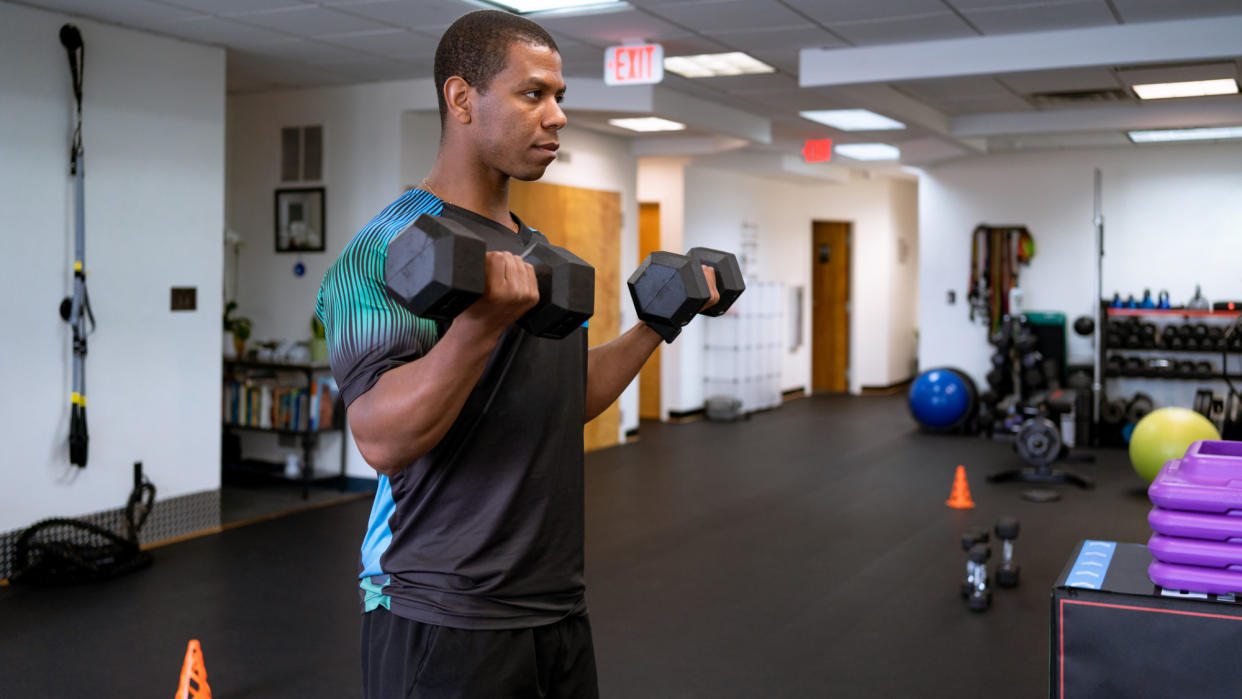  A man performing a dumbbell curl. 