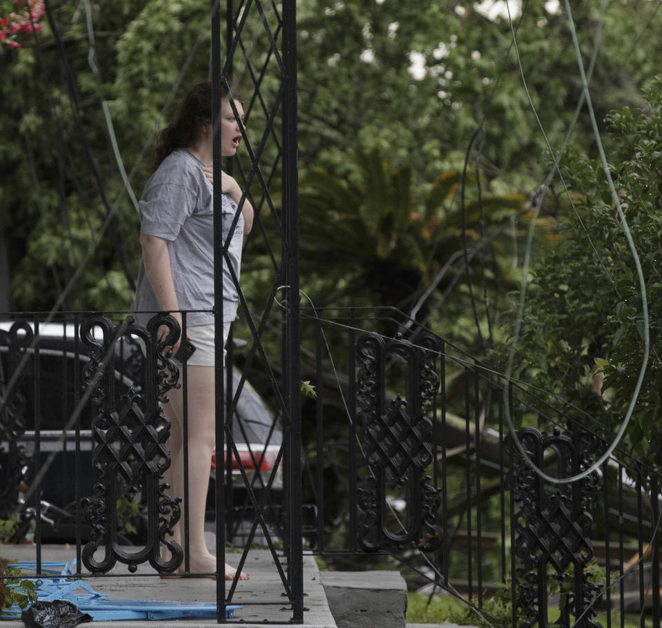 Lauren Duncan reacts to seeing the damage after powerful storms rolled through the city overnight in New Orleans Wednesday, May 12, 2021. (David Grunfeld/The Advocate via AP)