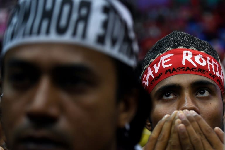 Rohingya Muslim refugees offer prayers during a gathering in Kuala Lumpur on December 4, 2016 against the persecution of the ethnic minority in Myanmar