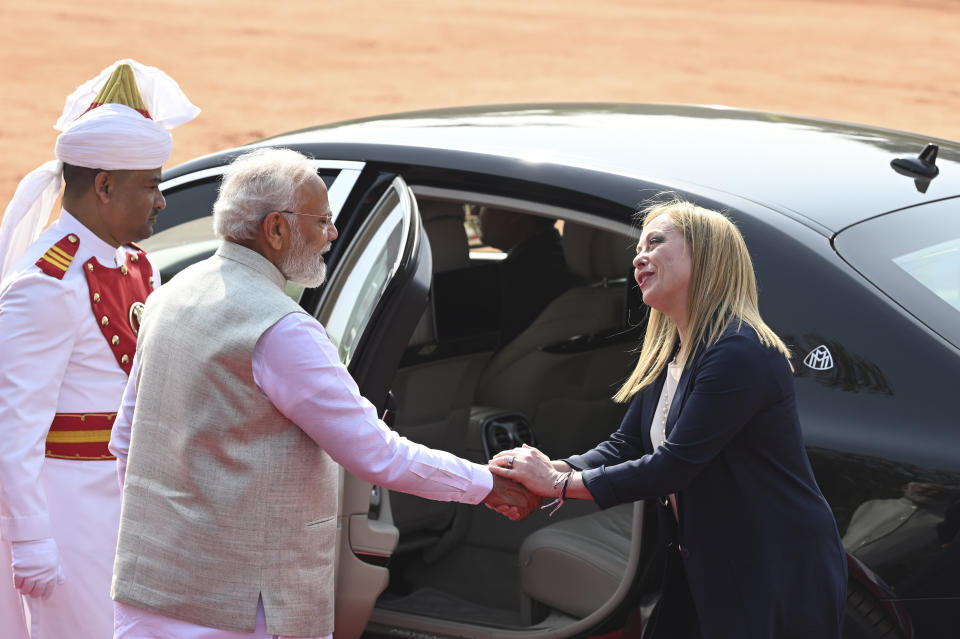 Italian Premier Giorgia Meloni, right, is received by Indian Prime Minister Narendra Modi, as she arrives for a ceremonial reception at the Indian Presidential Palace in New Delhi, India, Thursday, March 2, 2023.(AP Photo)