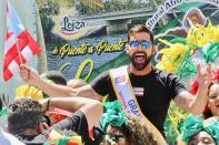 Grand Marshal Ricky Martin waves a flag at the Puerto Rican Day Parade on Sunday in New York City. 