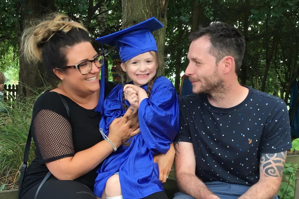 Paul and Nicole Doherty with their daughter Evie as she graduates pre-school