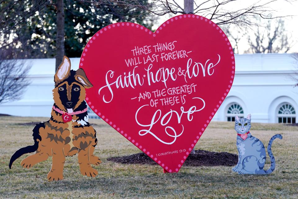 A Valentine's heart and depictions of President Joe Biden and first lady Jill Biden's pet dog Commander, left, and cat Willow, stand on the North Lawn of the White House in celebration of Valentine's Day, Monday, Feb. 14, 2022, in Washington.