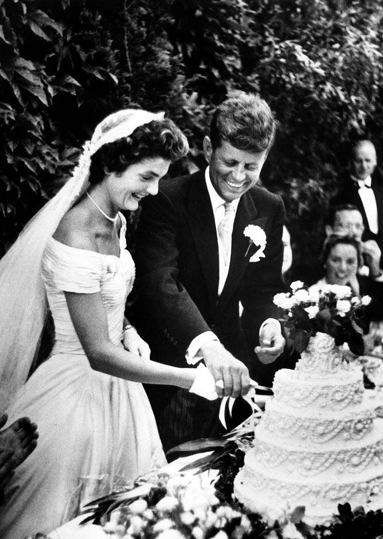 Then-Sen. John F. Kennedy and Jacqueline Bouvier cut the cake at the wedding reception held on Sept. 12, 1953, at Hammersmith Farm, Newport, Rhode Island.