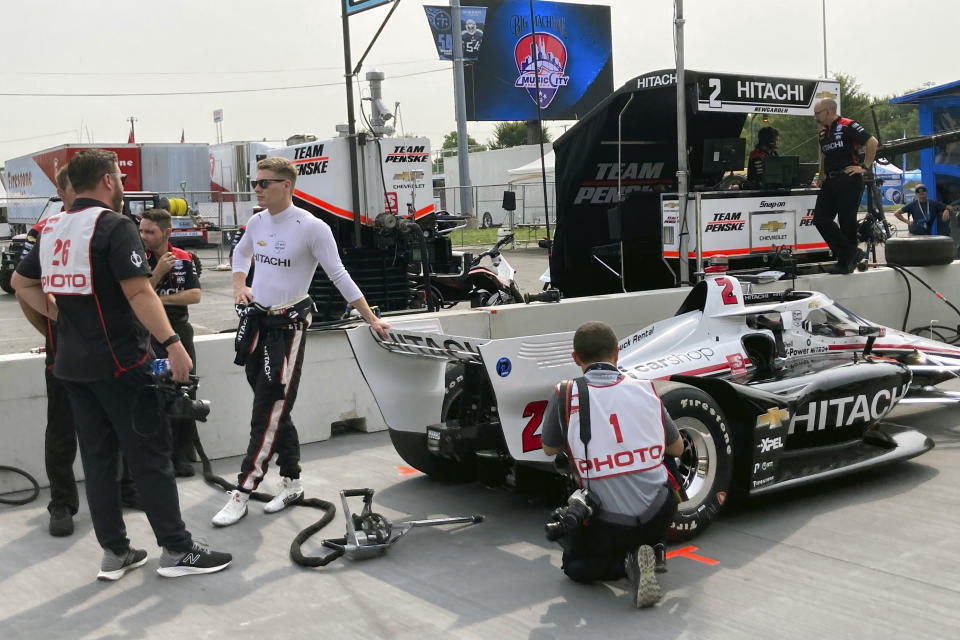 Tennessee native and two-time IndyCar champion Josef Newgarden leans on his car before he taking a ceremonial pace lap at the IndyCar auto race, Friday, Aug. 6, 2021, in Nashville, Tenn. (AP Photo/Dan Gelston)