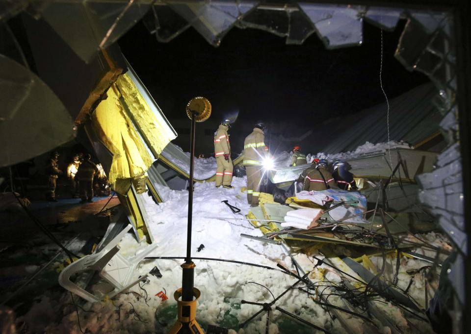 Firefighters search for survivors among debris from the collapsed resort building in Gyeongju