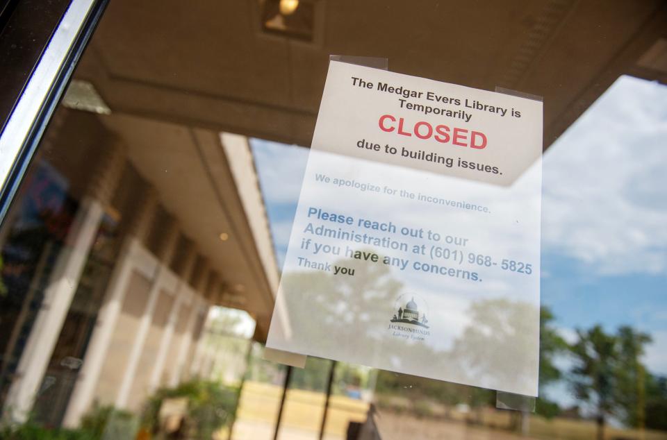 A sign taped to the front door of the Medgar Evers Library in Jackson, Miss., alerts patrons that the facility is "temporarily closed" Wednesday, Sept. 12, 2023. The library located on Medgar Evers Boulevard in Jackson, Miss., has been closed due to building issues since June 26.